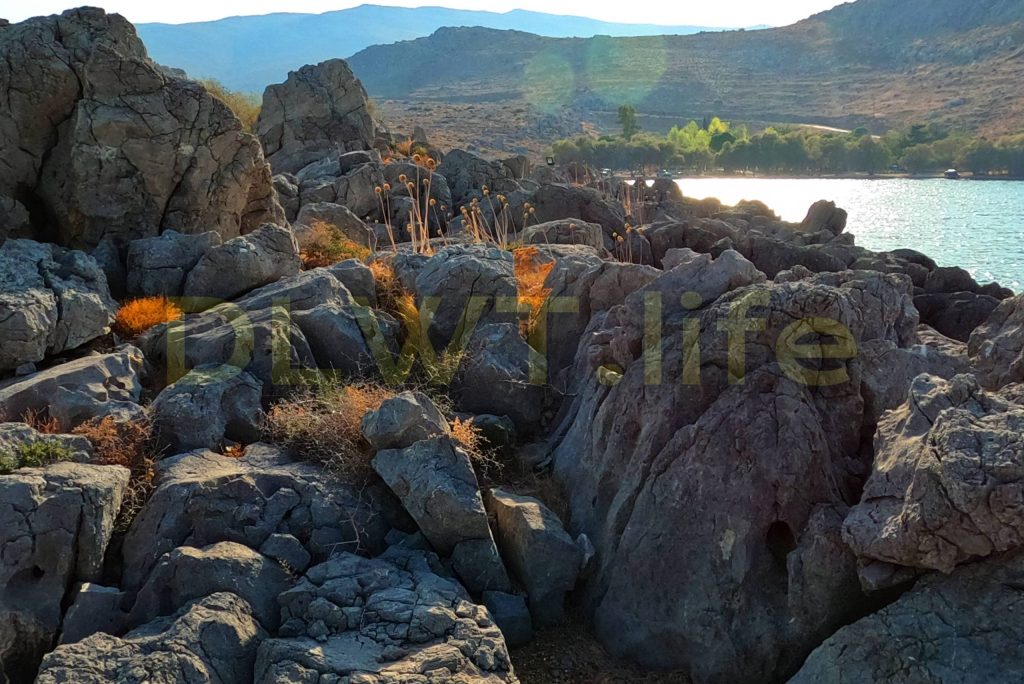 Hiking and Climbing on small Rocks of a Rocky Islet with the Sounds of Breathing, Sea and Helicopter
