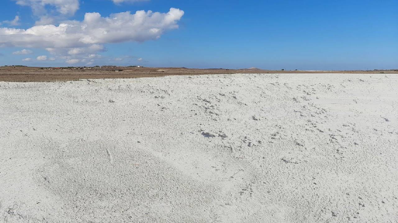 Walking on a Dry Lake (Lagoon) covered with White Pasty Soil