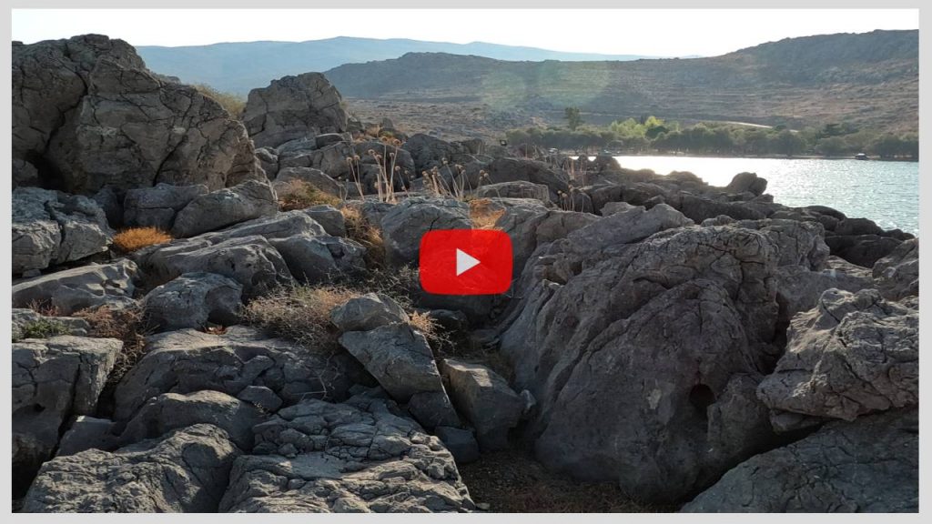 Hiking and Climbing on small Rocks of a Rocky Islet with the Sounds of Breathing, Sea and Helicopter